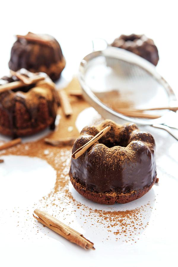 Mini Bundt Cakes Topped With Chocolate Glaze And Cinnamon Photograph by Anneliese Kompatscher