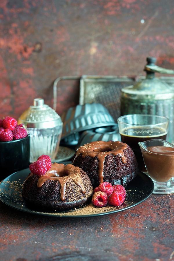 Mini Chocolate Bundt Cakes With Chocolate Sour Cream Icing With Fresh Raspberries Photograph by Irina Meliukh