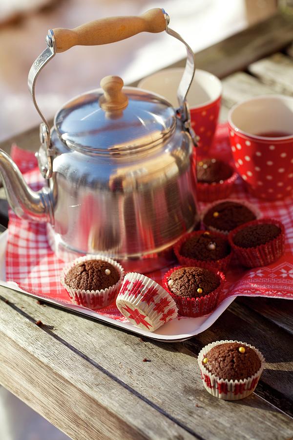 Mini Chocolate Muffins With A Tea Can And Cups On A Tray Photograph by Sabine Mader