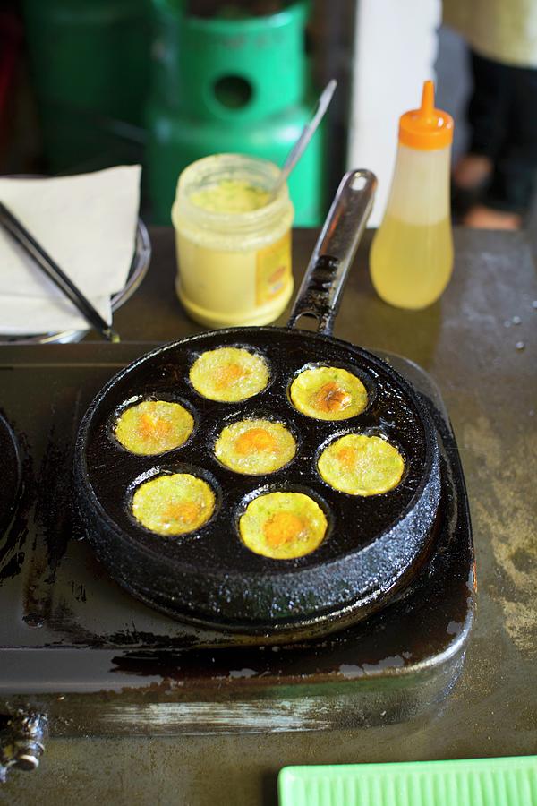 Mini Eggs Being Fried In A Pan vietnam Photograph by Anne Faber