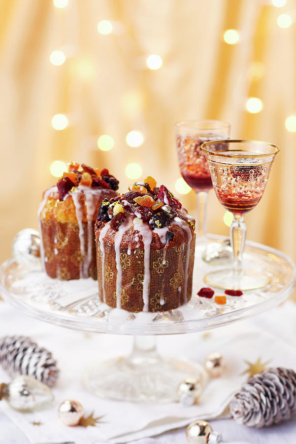 Mini Fruit Cakes Topped With Dried Fruit And Drizzled With Icing, Served On A Cake Stand Alongside Christmas Cocktails Photograph by Cliqq Photography