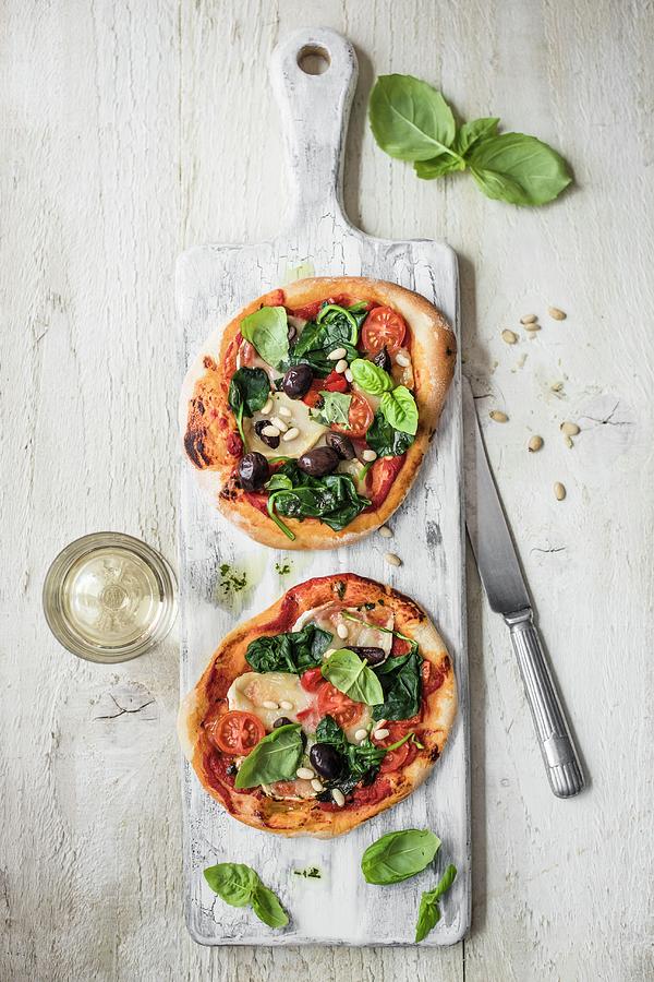 Mini Goats Cheese And Spinach Pizza With Pine Nuts, View From Above Photograph by Magdalena Hendey
