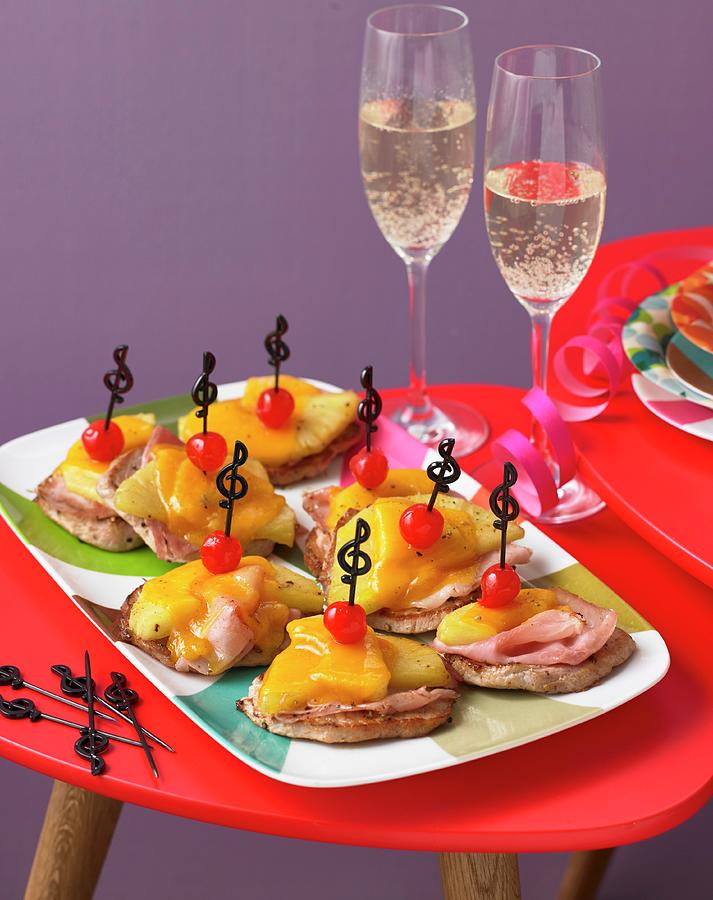 Mini Hawaiian Pizzas And Sparkling Wine For A Retro Party Photograph by Jan-peter Westermann