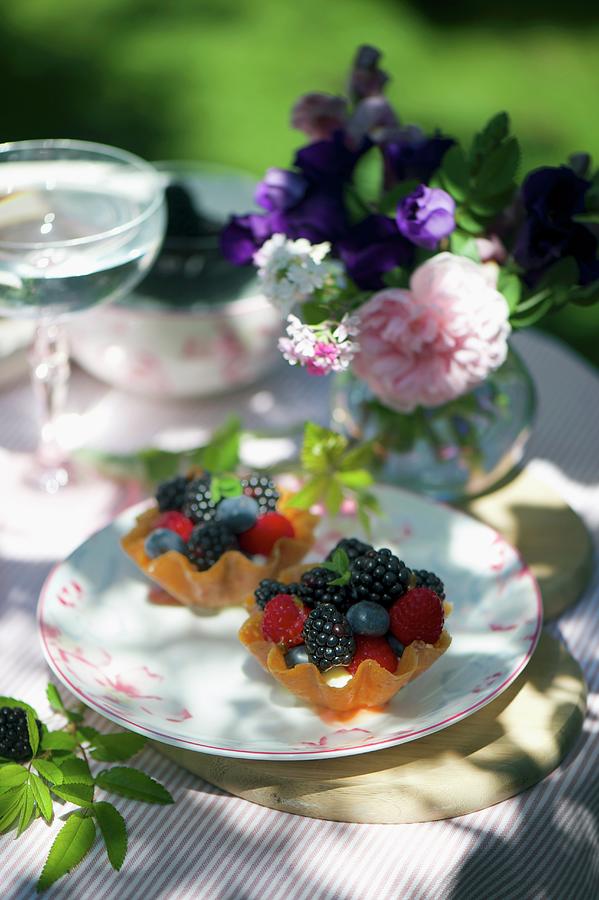 Mini Lemon Tartlets With Mixed Summer Berries Photograph by Winfried Heinze