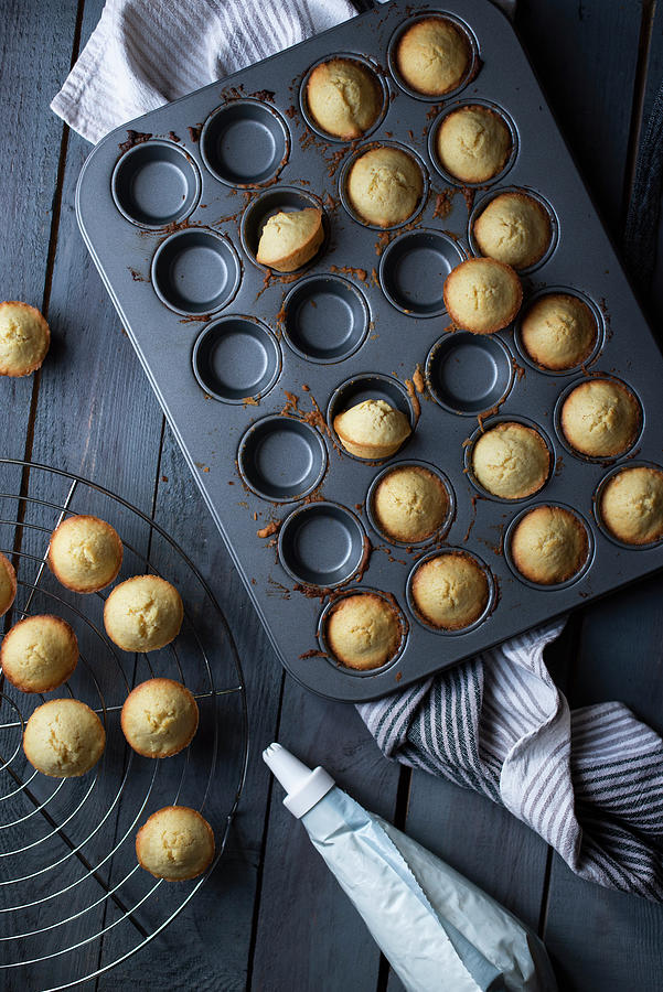 Mini Muffins In A Baking Pan On A Gray Wooden Table Photograph by Myriam Meliani