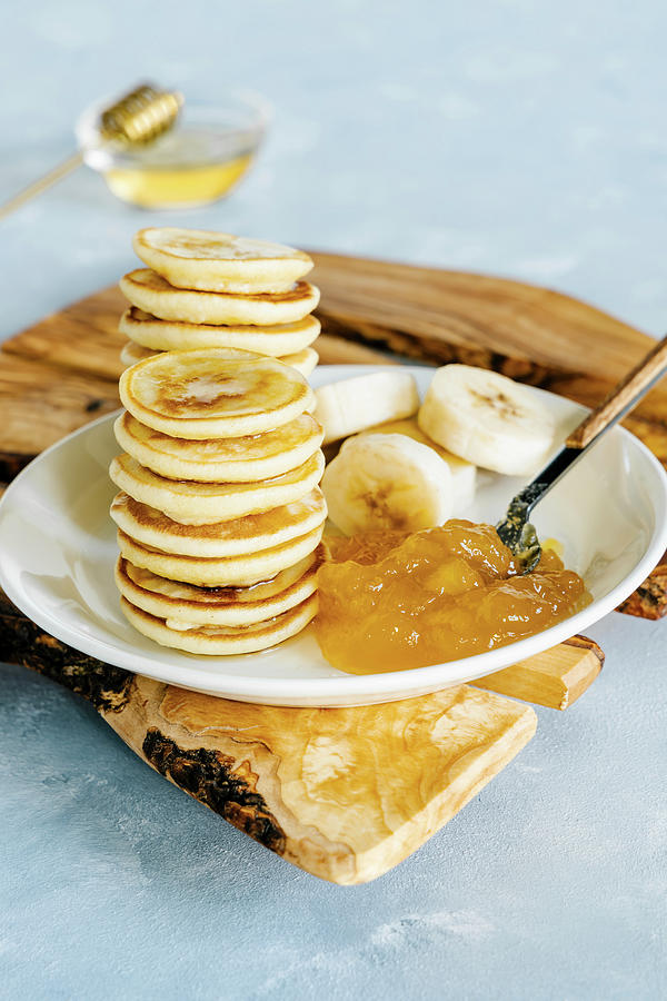 Mini Pancakes With Mango Pineapple Jam And Banana Photograph by Alla Machutt