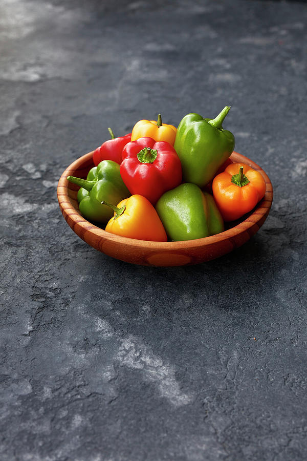 Mini Peppers In A Wooden Bowl Photograph by Rafael Pranschke