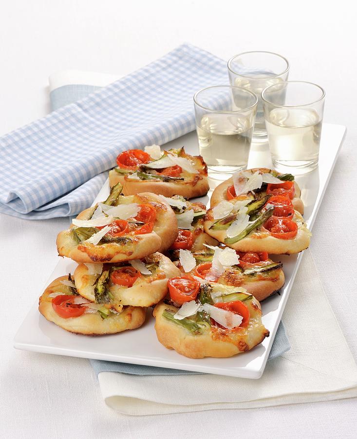 Mini Pizzas With Green Asparagus And Cherry Tomatoes Photograph by Franco Pizzochero