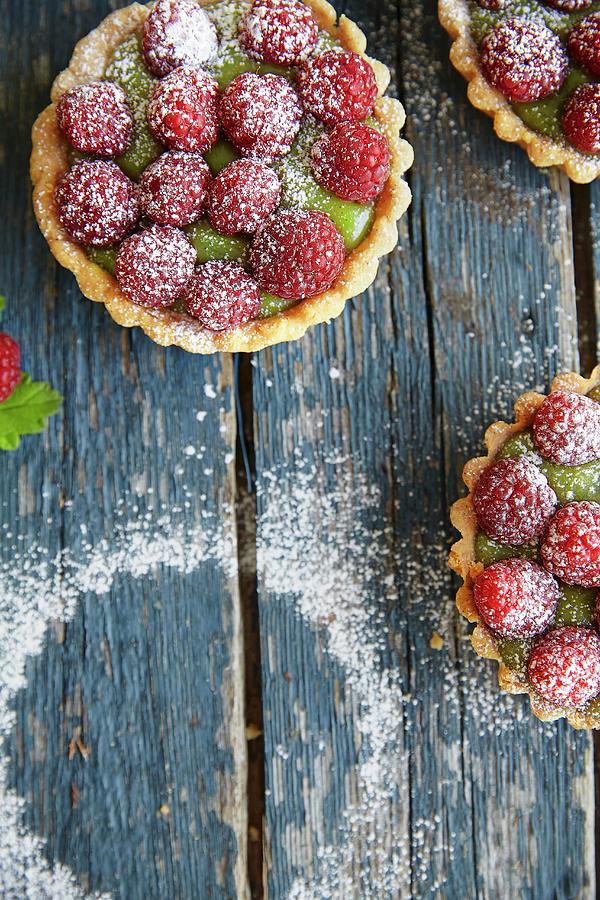 Mini Raspberry And Matcha Tartlets Dusted With Icing Sugar Photograph by Fanny Rdvik
