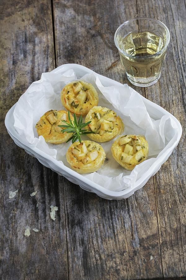 Mini Tartlets With Apples And Rosemary On A Porcelain Plate And A Glass Of White Wine Photograph by Tina Engel