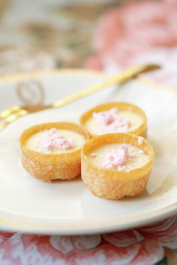 Mini Tarts Filled With Cream And Pink Meringues On A Glass Plate Photograph by Viola Cajo