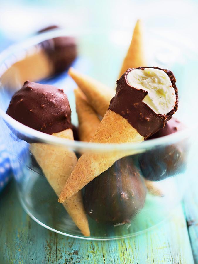 Ice Cream Photograph - Mini Vanilla Ice Cream Cones Coated In Chocolate And Amaretto Crumbs by Roulier-turiot