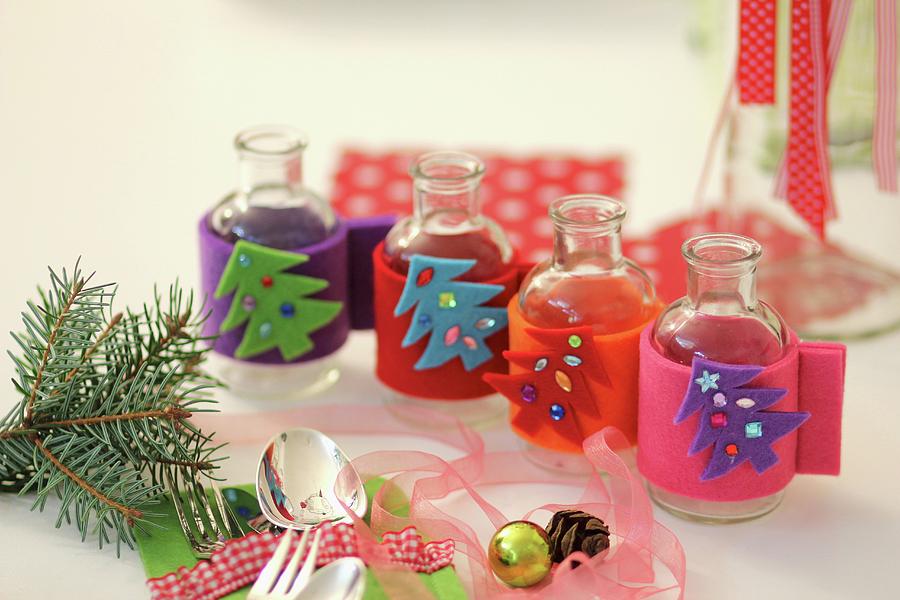 Mini Vases With Homemade, Felt Christmas Covers Photograph by Ruth Laing