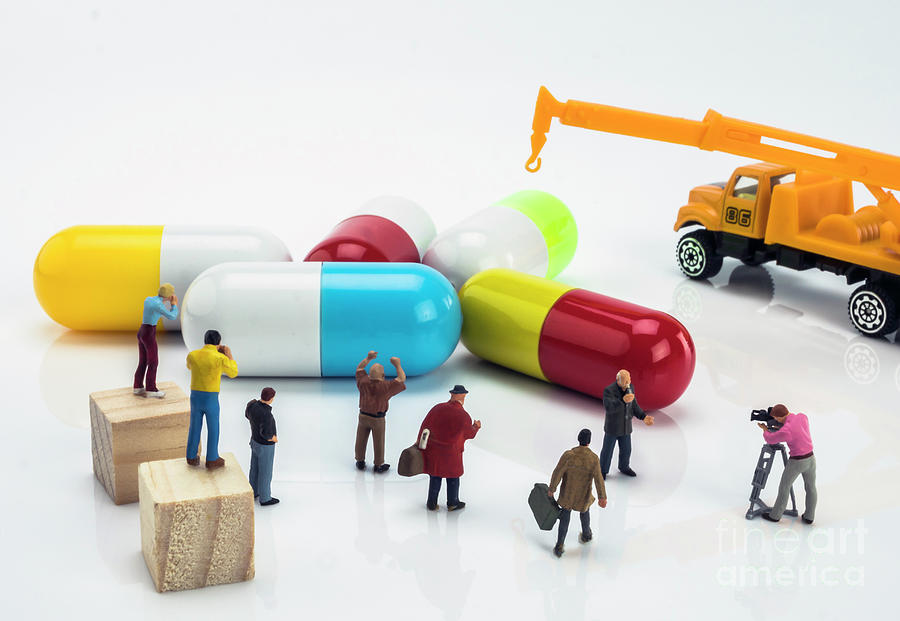 Miniature People Figures Next To Large Capsules Photograph by Digicomphoto/science Photo Library