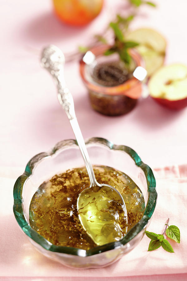 Mint And Apple Jelly In A Glass Bowl With A Silver Spoon Photograph by Teubner Foodfoto