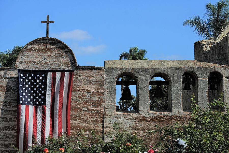 Mission San Juan Capistrano California Left Exterior Wall American Flag And Bells Photograph by Michael Hoard