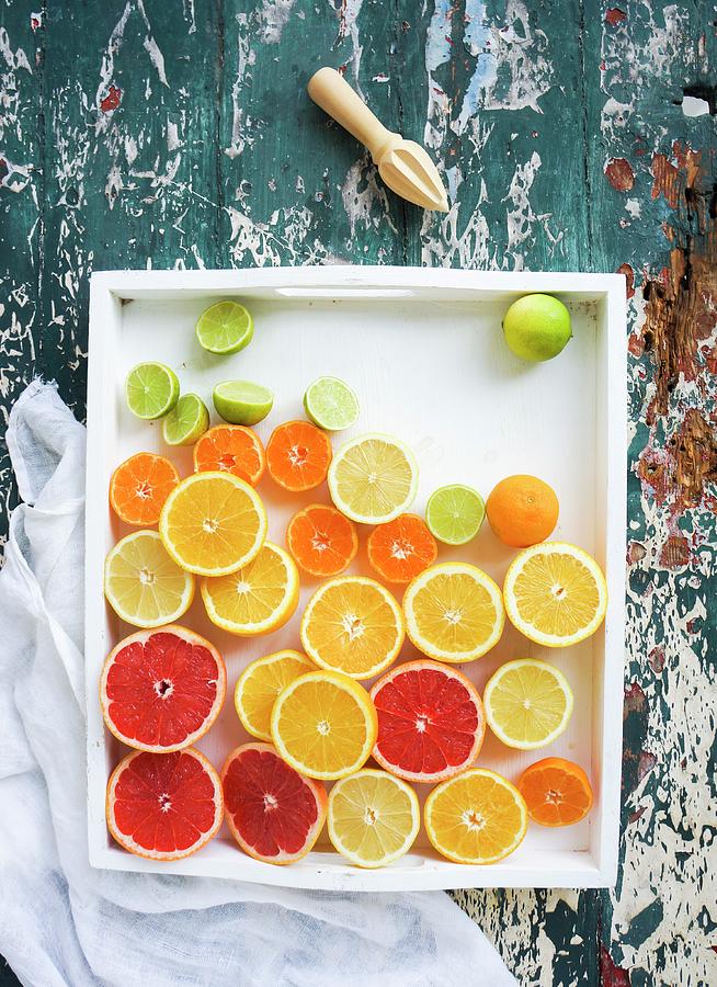 Mixed Citrus Fruit Halves In A Dish Photograph by Velsberg