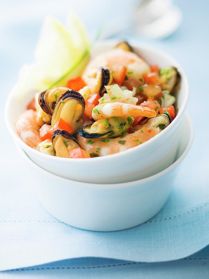 Mixed Shrimps, Mussels And Diced Tomatoes With Chopped Parsley Photograph by Roulier-turiot
