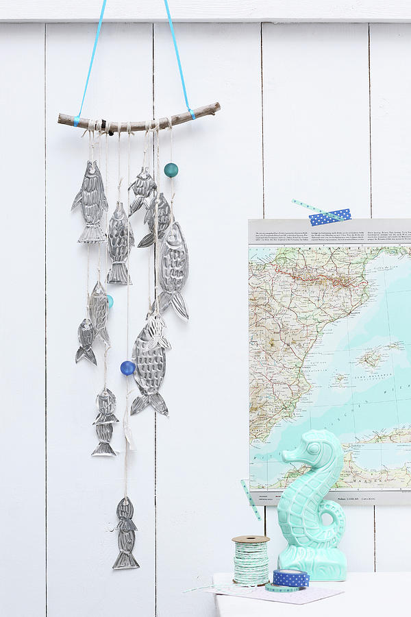 Fish Photograph - Mobile Of Hand-made Metal Fish Hung On Board Wall by Thordis Rggeberg