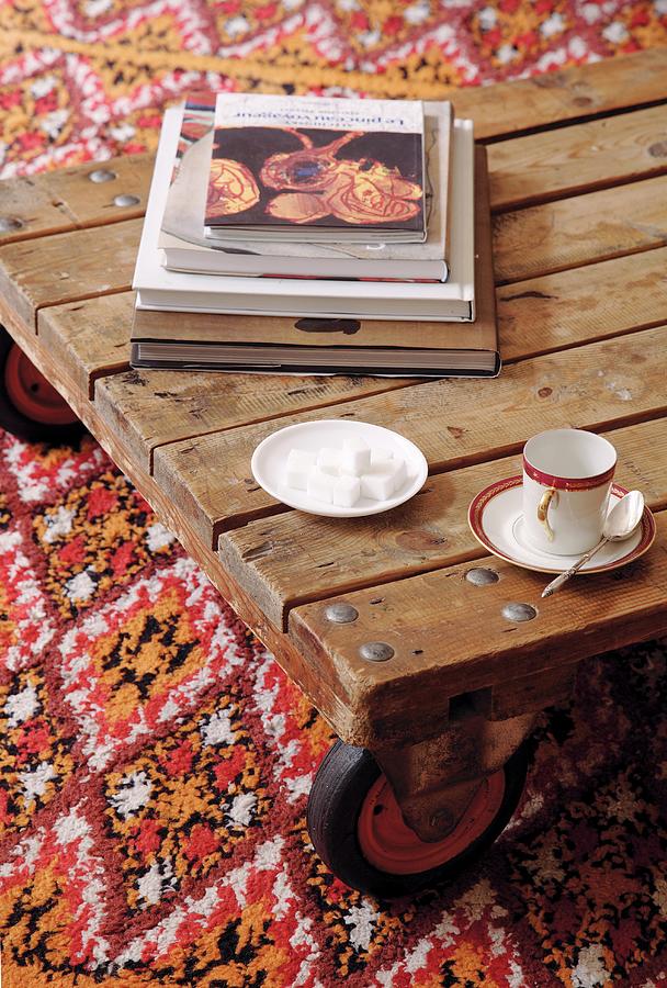 Mocha Cup And Saucer And Sugar Cubes On Low Wooden Table With Castors On Patterned Rug Photograph by Jos-luis Hausmann