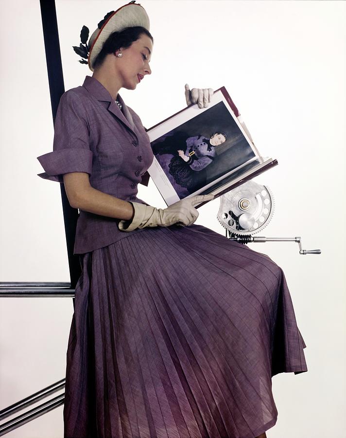 Model In Purple With Book Of Paintings Photograph by John Rawlings
