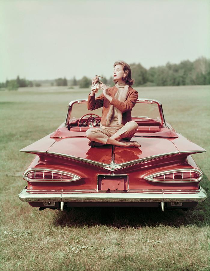Model Sitting On A Chevrolet Convertible Photograph by John Rawlings