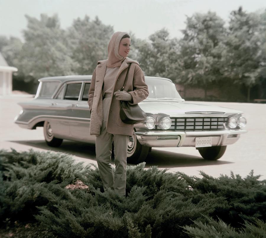Model With An Oldsmobile Station Wagon Photograph by John Rawlings