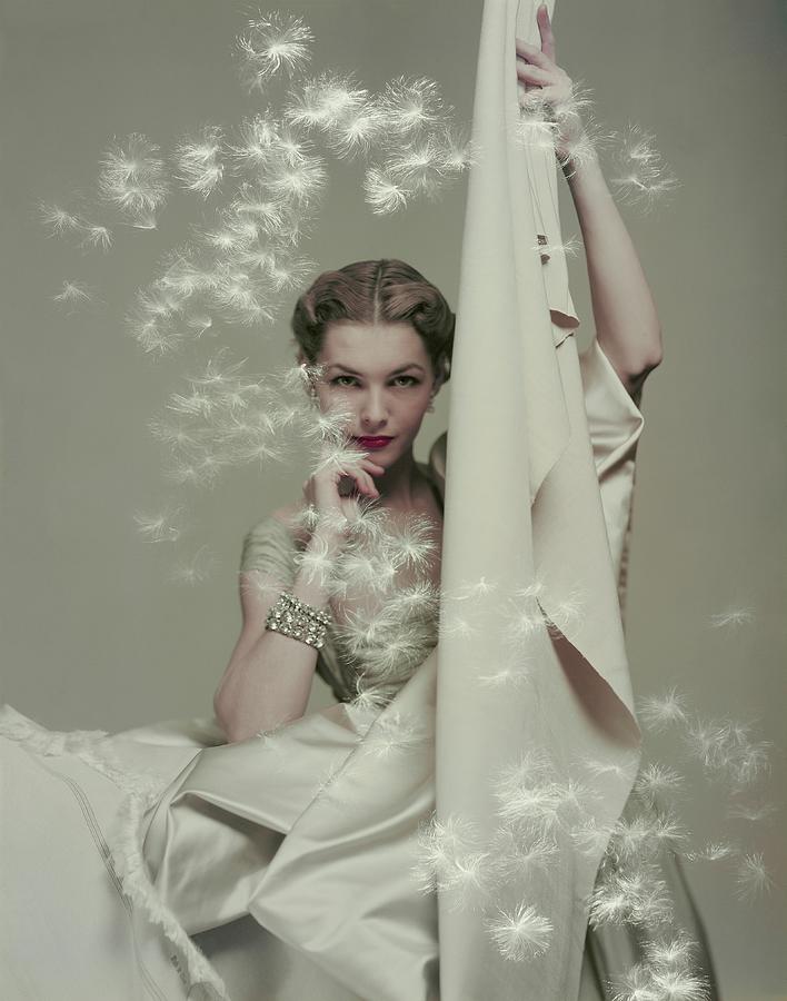 Model With Silk And Floating Dandelion Seeds Photograph by Herbert Matter