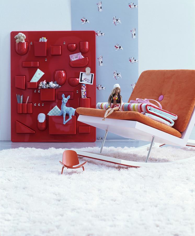 Modern Rocking Chair In Front Of Toys In Red Organiser On Wall Photograph by Matteo Manduzio