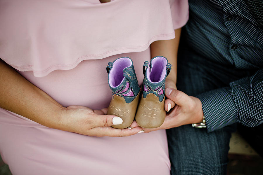 Boot Photograph - Mom And Dad To Be Holding Baby Boots by Cavan Images