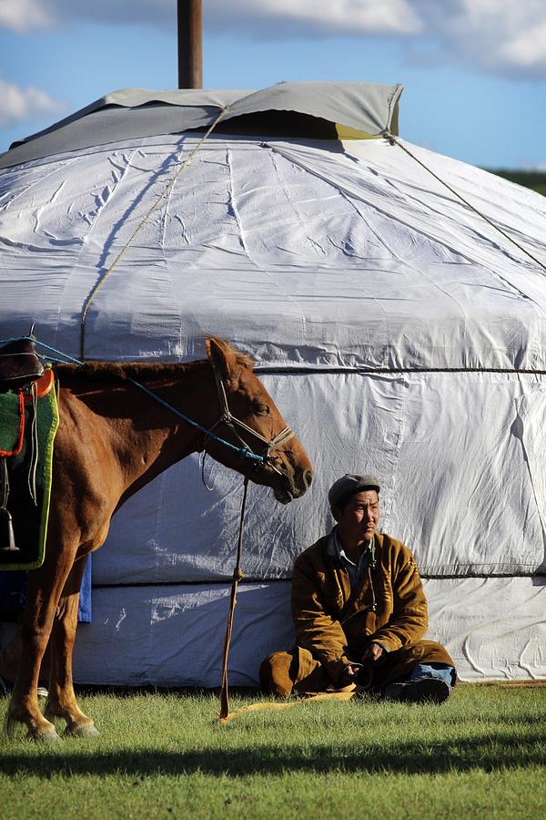 Mongolian Herder Sits Outside Ger With Photograph by Timothy Allen Mongolian Herder Sits Outside Ger With Photograph by Timothy Allen