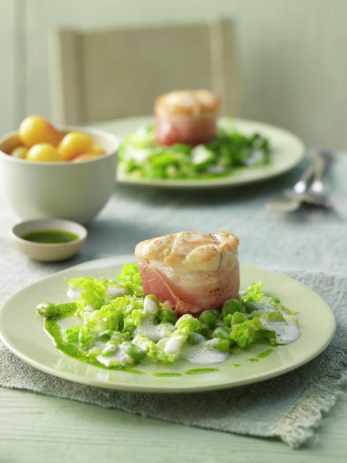 Monk Fish Tournedos In Bacon With Basil Oil On Green Bean Seeds And Lettuce Strips Photograph by Jan-peter Westermann