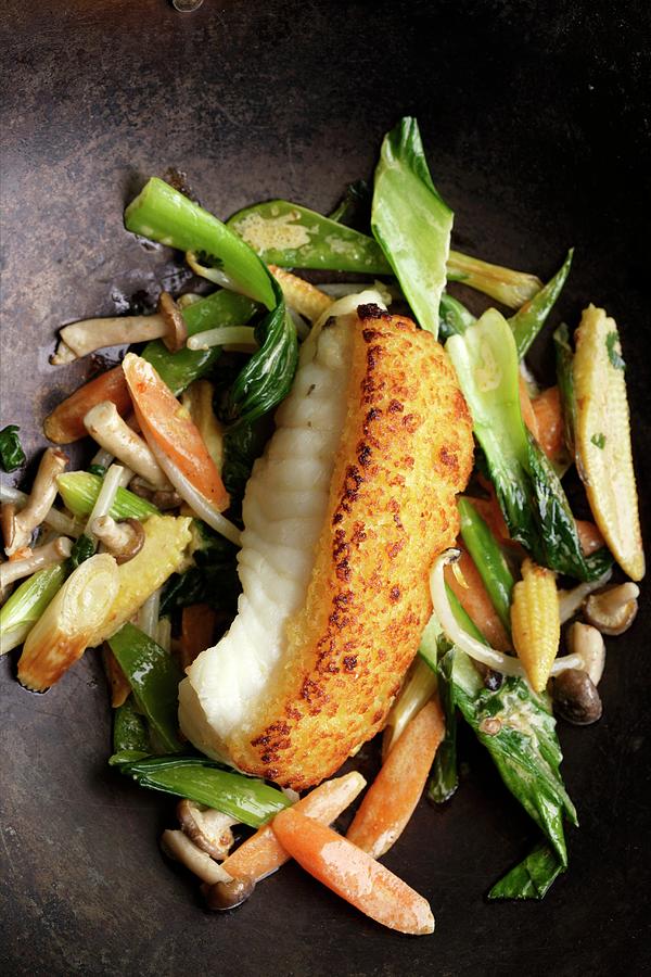Monk Fish With A Ginger Crust On A Bed Of Stir-fried Vegetables With Coconut Milk Photograph by Michael Wissing