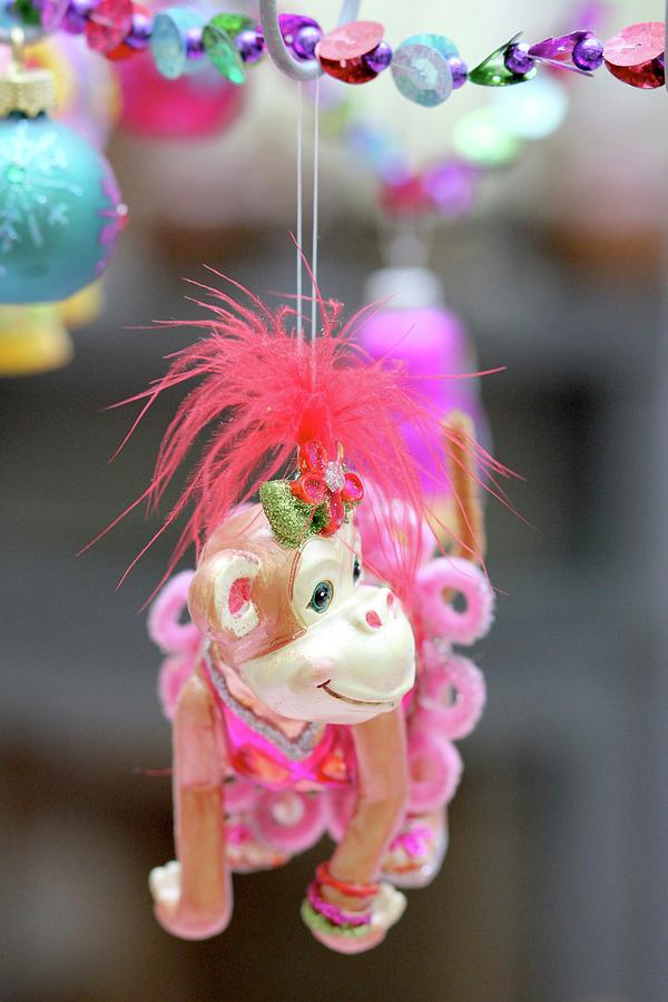 Monkey Toy With Feminine Clothing Hanging From String Of Colour Beads As Christmas Decoration Photograph by Ruth Laing
