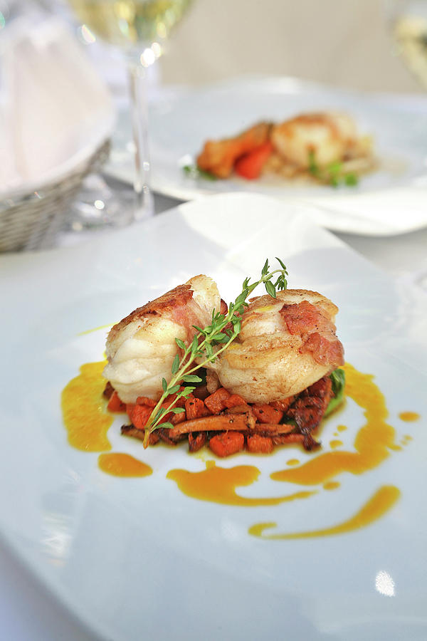 Monkfish Medallions Wrapped In Bacon Served With Chanterelles On Plate ...