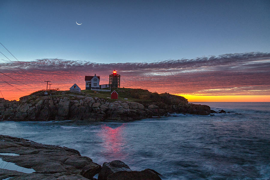 Moon over Nubble Photograph by Rod Best