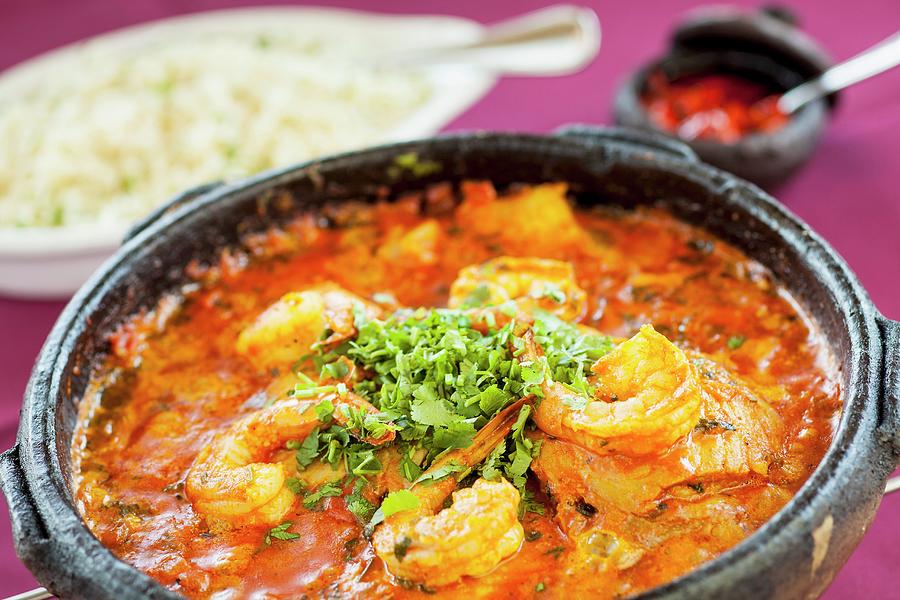 Moqueca brazilian Stew With Fish And Prawns In A Terracotta Pot With Rice In The Background Photograph by Chuck Place