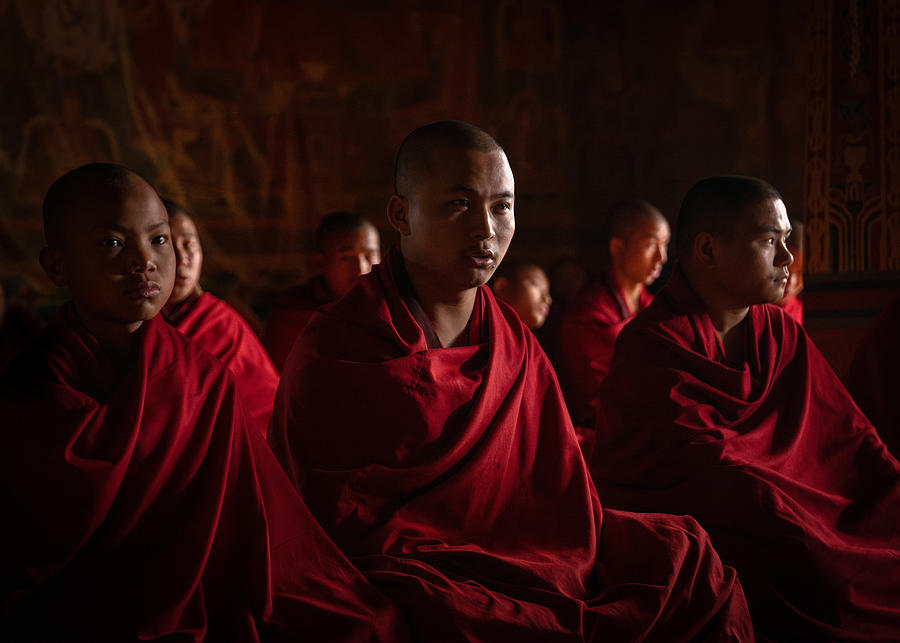 Portrait Photograph - Morning Devotion: Illuminated Prayers At Chorten Ningpo Monastery, Bhutan by Rudy Mareel