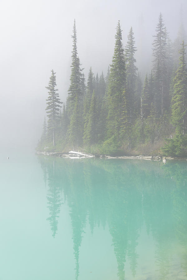 Morning mist rising from  turquoise lake Photograph by Steve Estvanik