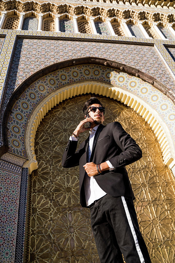 Moroccan Man With Sunglasses And Suit Using Smart Phone Together