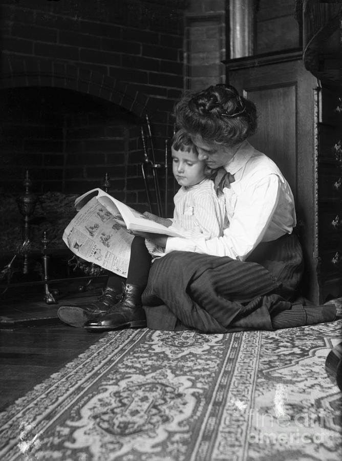 Mother And Child Reading By Fireplace Photograph by Bettmann
