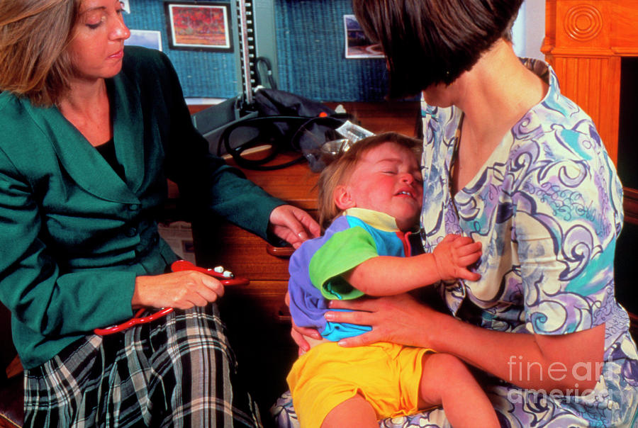Mother And Distressed 15-month-old Boy At Doctors Photograph by Mark Clarke/science Photo Library