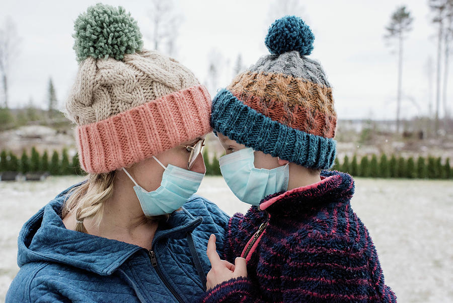 Winter Photograph - Mother And Son Looking At Each Other With Face Masks For Protection by Cavan Images