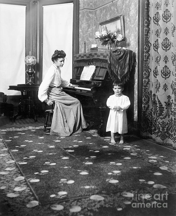 Mother At Piano With Child In Nightshirt Photograph by Bettmann