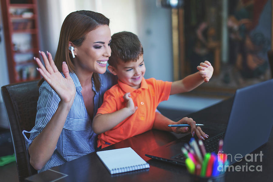 Mother Smiling With Son Waving At Laptop During Video Call Photograph by Sakkmesterke/science Photo Library