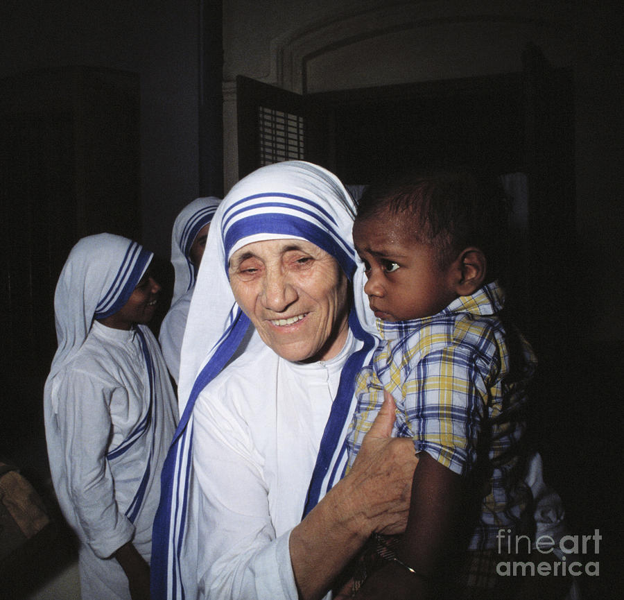 Mother Teresa Holding Young Boy Photograph by Bettmann