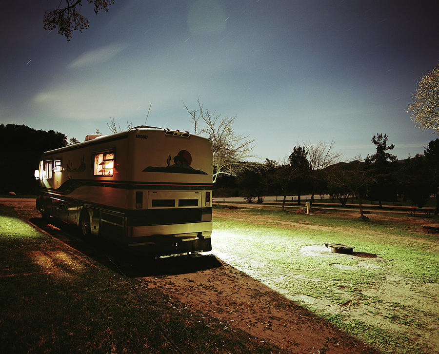 Motorhome Parked In Campgrounds At Night by Jason Dewey