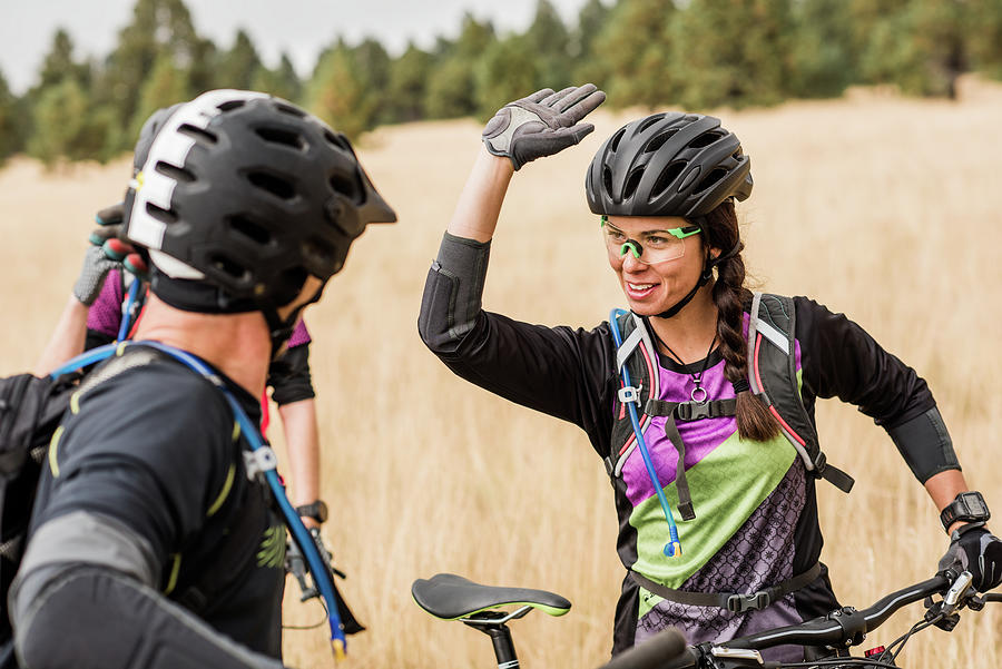 Mountain Bike Friends High Five Photograph by Cavan Images - Pixels