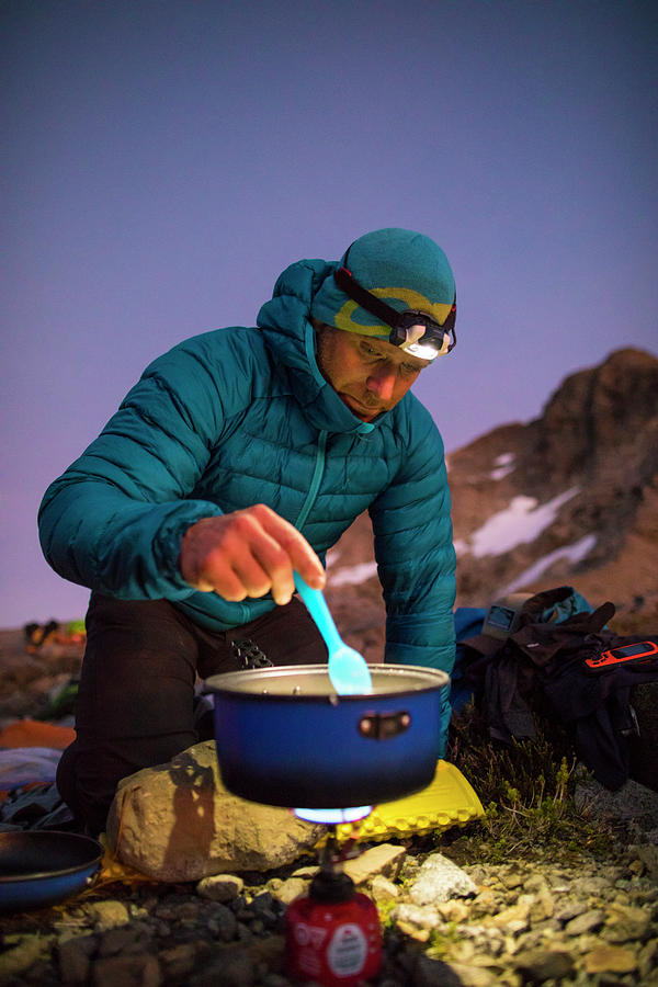 Mountaineer Cooking A Meal On An Ultralight Stove In The Mountains ...