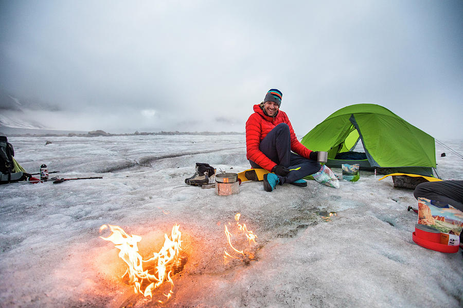 Mountaineer Enjoys Moving Campfire On Glacier In The Artic. Photograph ...